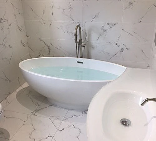 full bath and white tiles.